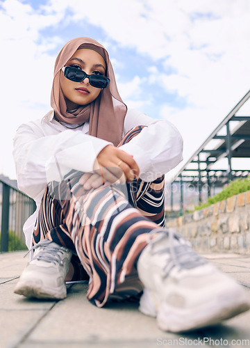 Image of Portrait, fashion or hijab with an islam woman outdoor in sunglasses and scarf for contemporary style. Arab, faith or burka with a trendy young muslim person outside in a city wearing modern clothes