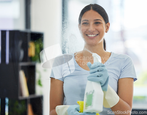 Image of Smile, woman and cleaning glass with bottle, gloves and detergent for housekeeping in home or office. Cleaner, service and female domestic cleaner with product for bacteria, dust or germ prevention