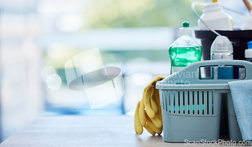 Image of Basket, table and product for cleaning with space, cloth and chemical for mockup by blurred background in home. House, mock up and plastic container for services, stop bacteria and dust in interior