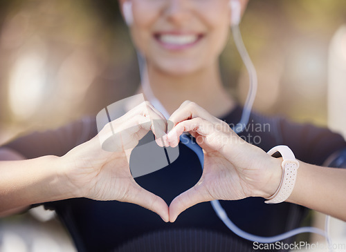 Image of Healthy, heart hands or happy girl runner in park for fitness, exercise or workout for cardiovascular health. Love sign, hand gesture or blurry sports woman in sports training for wellness in nature