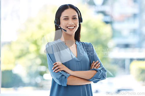 Image of Woman with arms crossed, portrait and callcenter, contact us with customer service agent in workplace with smile. CRM, communication and tech support, female consultant for help desk and mockup space