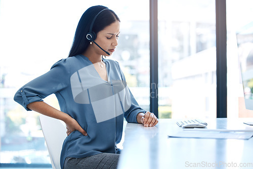 Image of Back pain, stress and woman at a call center with posture issue while working for telemarketing in office. Spine, backache and female consultant with anxiety, joint or problem while consulting in crm