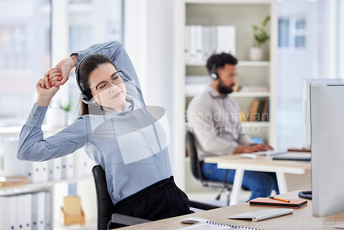 Image of Consultant, lazy woman call center agent with stretch and tired at her desk with a computer of workplace. Online communication or telemarketing, burnout and female person stretching for fatigue