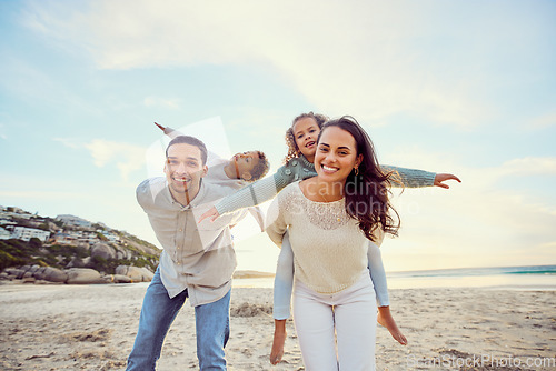 Image of Beach, piggyback and portrait of parents and children for family holiday, summer vacation and weekend. Nature, travel and happy mom, dad and kids playing by ocean for bonding, fun and quality time