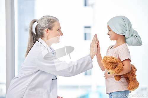 Image of Cancer, child and doctor high five in support, healthcare service and success or empathy, love and healing in hospital. Happy girl or sick kid and pediatrician or medical woman help or hands together