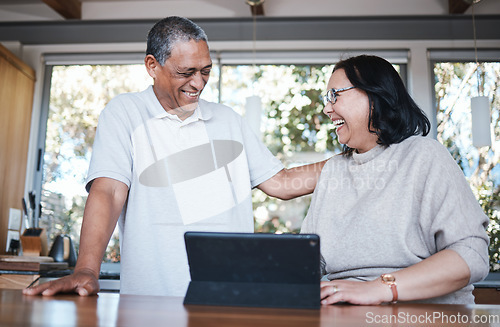 Image of Happy, laughing and senior couple with digital tablet in a kitchen, relax and bonding in their home. smile, laugh and old people enjoying retirement, joke and fun while browsing online in their house