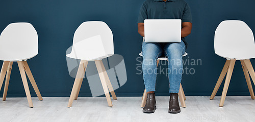 Image of Job interview, waiting room and man with laptop for email or research while waiting in hr office. Recruitment, opportunity and male candidate online for application, process or we are hiring website