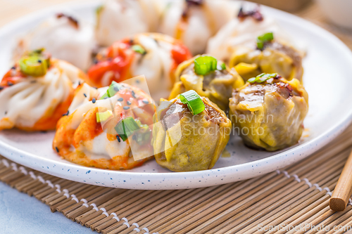 Image of Assortment of steamed dumplings Dim Sum on kitchen table