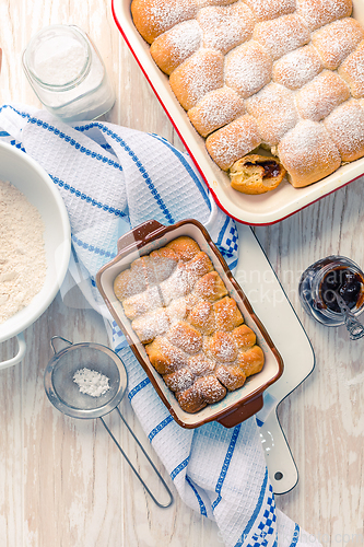 Image of Sweet rolls, Buchteln (buchty) filled with plum jam or jelly with backing ingredients