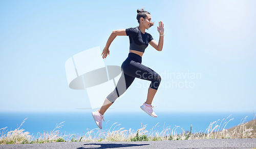 Image of Runner woman, street and jump in nature with speed, fitness and energy for training, wellness and healthy by sea. Girl, running and fast on road for self care, exercise and workout by ocean in summer