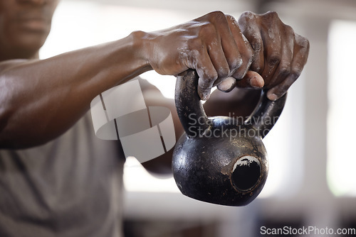 Image of Kettlebell, hands and exercise with a man at gym for fitness, training and strong muscle growth. Athlete or bodybuilder person at club for iron weights workout for power and performance with powder