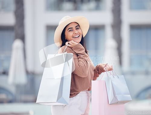 Image of Happy woman in portrait, shopping bag and retail at outdoor mall, smile with purchase, luxury and shop discount. Female customer, fashion designer brand and buyer choice with store promotion and sale