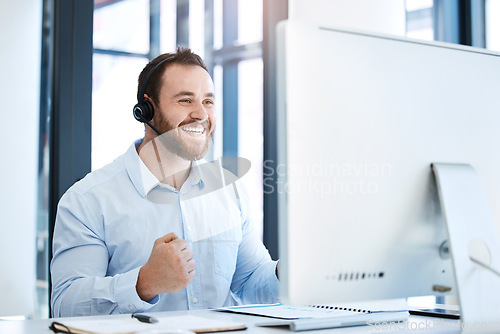 Image of Happy man, call center and fist in celebration for winning, bonus or sales promotion at the office. Excited businessman, consultant or agent in joy for win, victory or customer service at workplace