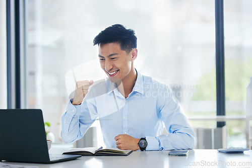 Image of Asian business man, fist celebration and happy for winning, goals or profit on stock market, gambling or esports. Japanese businessman, winner and laptop with happiness, celebrate success and fintech