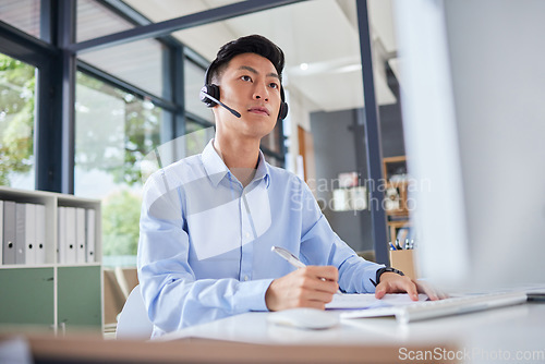 Image of Call center, writing and focus with business man in office for consulting, contact us and telemarketing. Communication, customer service and help desk with Asian employee for receptionist and advice