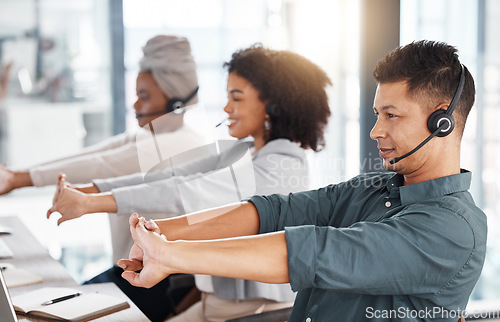 Image of Call center, headset and team stretching at desk while tired or to start telemarketing work. Diversity women and a man together at a desk to exercise for crm, customer service and help desk support