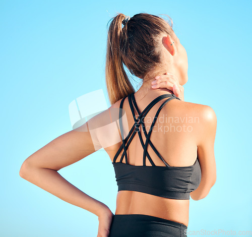 Image of Fitness, back view of woman with neck pain and in blue sky outdoors for yoga exercise. Workout or training for health wellness, sports athlete and female person struggling with cramp in muscle