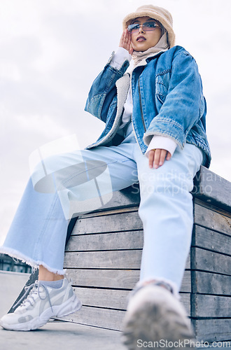 Image of Portrait, fashion or city life with a muslim woman outdoor in a cap and scarf for contemporary style. Islam, faith and hijab with a trendy young arab female person posing outside in an urban town