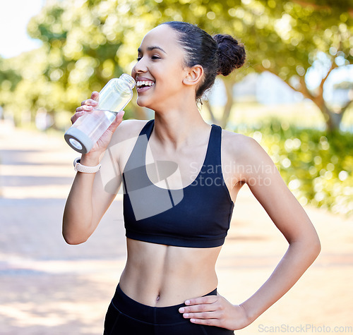 Image of Happy woman, fitness and laughing with water bottle in rest from fun running, exercise or cardio workout in park. Fit, active or thirsty female person, athlete or runner with smile for sustainability