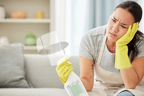 Image of Product, maid and woman tired from cleaning furniture, counter and table in apartment living room. Housework, exhausted and frustrated worker with spray bottle to clean with products in hands