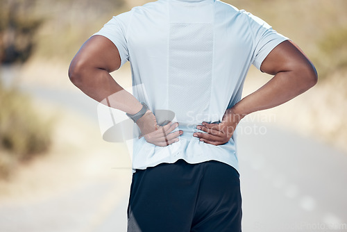 Image of Back pain, fitness and man on the road, training and exercise with muscle tension, strain and emergency. Male person, guy and athlete with joint injury, outdoor and accident with a health problem