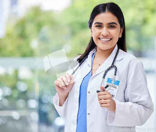 Image of Young woman, doctor and hospital portrait with smile, stethoscope and healthcare career with pride. Female latino medic, happy health and wellness expert with medical job, clinic and help in services