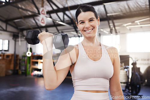 Image of Dumbbells, happy and exercise with a woman at gym for fitness, training workout and strong muscle. Portrait of athlete person with iron weights for power, motivation and performance at wellness club