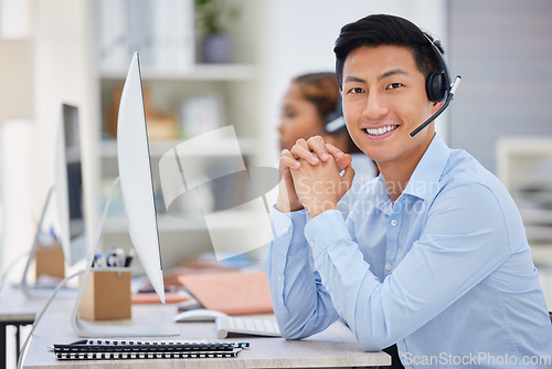 Image of Business man, portrait and call center consultation in a office working on a computer. Smile, Asian male worker and web support advice of a contact us employee with professional communication at job