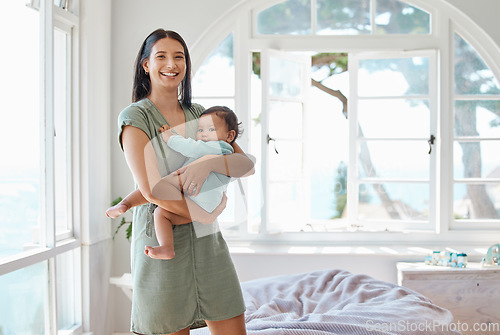 Image of Portrait, happy mother and holding baby in home for love, care or quality time together for childcare development. Mom carrying infant kid, newborn girl and smile in support, comfort and nursery room