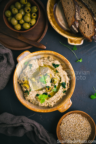 Image of Traditional arabian eggplant dip (baba ganoush) on rustic dark t