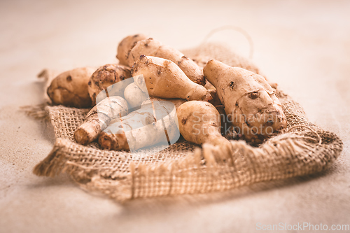 Image of Fresh organic topinambur on wooden background