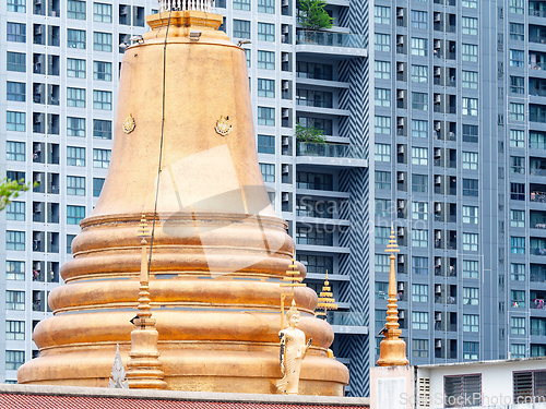 Image of Golden pagoda and modern condo in Bangkok, Thailand
