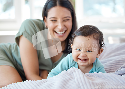 Image of Mother, laughing baby and play on bed in home for love, care and quality time together with joy, growth and kids development. Happy mom, infant child and crawling for fun with newborn girl in bedroom