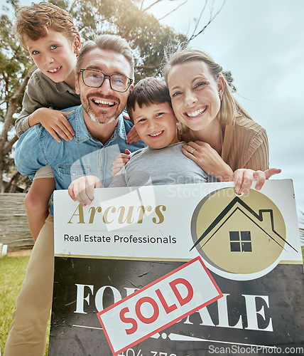 Image of Parents, kids and real estate sale with poster, portrait and smile for new home, start and investment for future. Father, mother and boy children with sold sign, property investing and family house