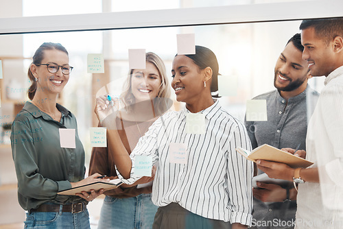 Image of Meeting, coaching and a business woman writing on glass with her team for strategy or brainstorming in an office. Collaboration, planning and leadership with a female employee teaching her colleagues