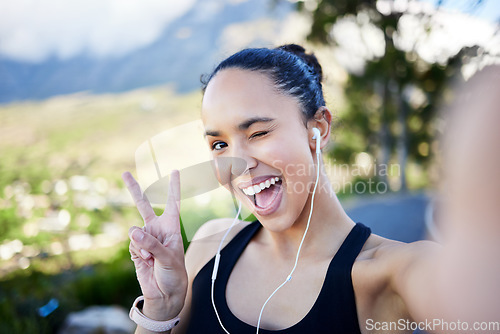 Image of Happy woman, fitness and selfie with peace sign for profile picture in social media or online post in nature. Portrait of funny female person or runner with fun expression for photo or vlog outdoors