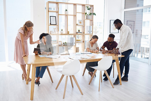 Image of Documents, meeting and people in workspace for business startup, project management and review, teamwork or planning. Diversity, group of women and men or team talking on digital tablet or paperwork