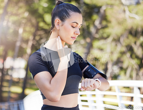 Image of Woman runner, watch and neck for pulse in park, bridge or outdoor for fitness, health or training for sport. Girl, heart rate and check clock for running, performance or wellness in summer sunshine