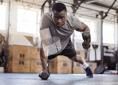 Image of Dumbbells, push up and exercise with a black man at gym for fitness, training workout and strong muscle. Serious African athlete or bodybuilder person with weights for power, focus and performance