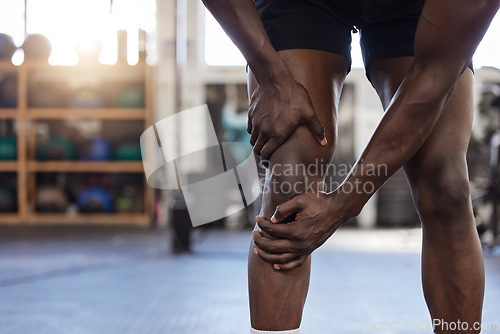 Image of Closeup, fitness and black man with knee pain, injury or hurt with medical problem, workout or training. Zoom, male person or athlete with muscle tension, sport accident or leg tension with emergency