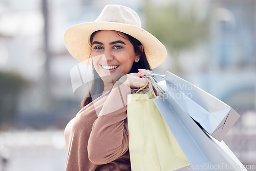 Image of Woman in portrait, smile with shopping bag and retail at outdoor mall, luxury purchase and shop discount. Happy female customer, fashion designer brand and buyer choice with store promotion and sale