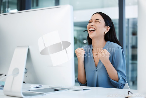 Image of Happy woman, call center and fist in celebration for winning, bonus or sales promotion at office. Excited female person, consultant or agent in joy for win, victory or customer service at workplace