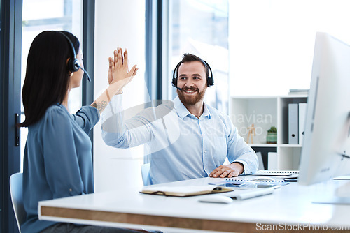 Image of High five, callcenter team and contact us, phone call success and people celebrate in office. CRM, communication and solidarity in customer service, man and woman help desk consultant with motivation