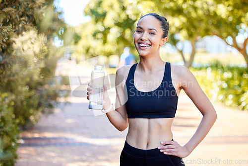 Image of Happy woman, fitness and portrait with water bottle in rest after running, exercise or cardio workout in park. Fit, active and thirsty female person, athlete or runner with smile for sustainability