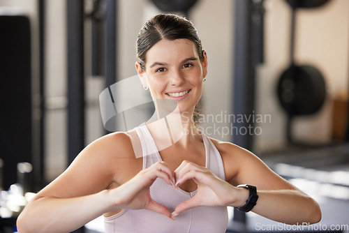 Image of Woman, hands and heart shape for exercise at gym for fitness, training workout or healthy lifestyle. Happy athlete person with hand, sign and icon or emoji for love, wellness or cardiovascular health