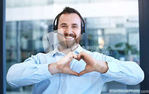 Image of Callcenter agent, man with smile and heart hands in portrait, love customer service job and feedback. Hand gesture, care emoji and male consultant is happy with job at contact center and tech support