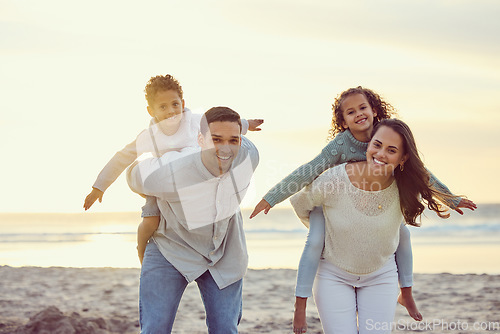 Image of Portrait of parents piggyback kids on beach for family holiday, summer vacation and weekend. Nature, travel and happy mother, father and children playing by ocean for bonding, fun and quality time