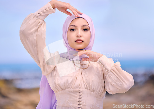 Image of Portrait, fashion or faith with a saudi woman outdoor in a scarf for religion or contemporary style. Islam, face or hijab with a trendy young muslim person posing outside in nature for modern clothes