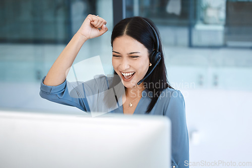 Image of Happy woman, call center and fist in celebration for promotion, success or winning bonus at office. Excited female person, consultant or agent in joy for win, victory or customer service at workplace