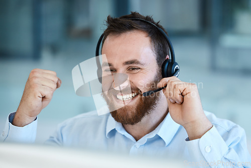 Image of Happy man, call center and fist in celebration for success, promotion or winning bonus at the office. Excited businessman, consultant or agent in joy for win, victory or customer service at workplace